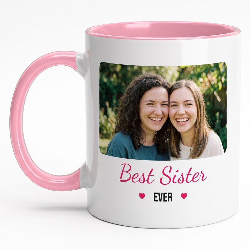 A pink-rim "Best Sister Ever" mug with two sisters cheek to cheek in a garden