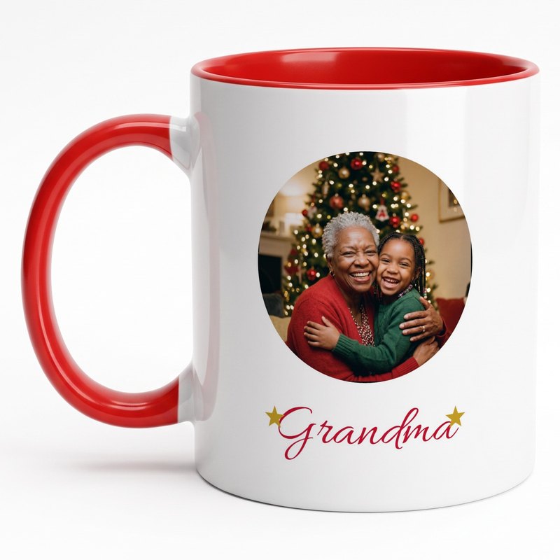 A red-rim mug with a grandmother and granddaughter by the Christmas tree in a circle, "Grandma" in red script and two gold stars