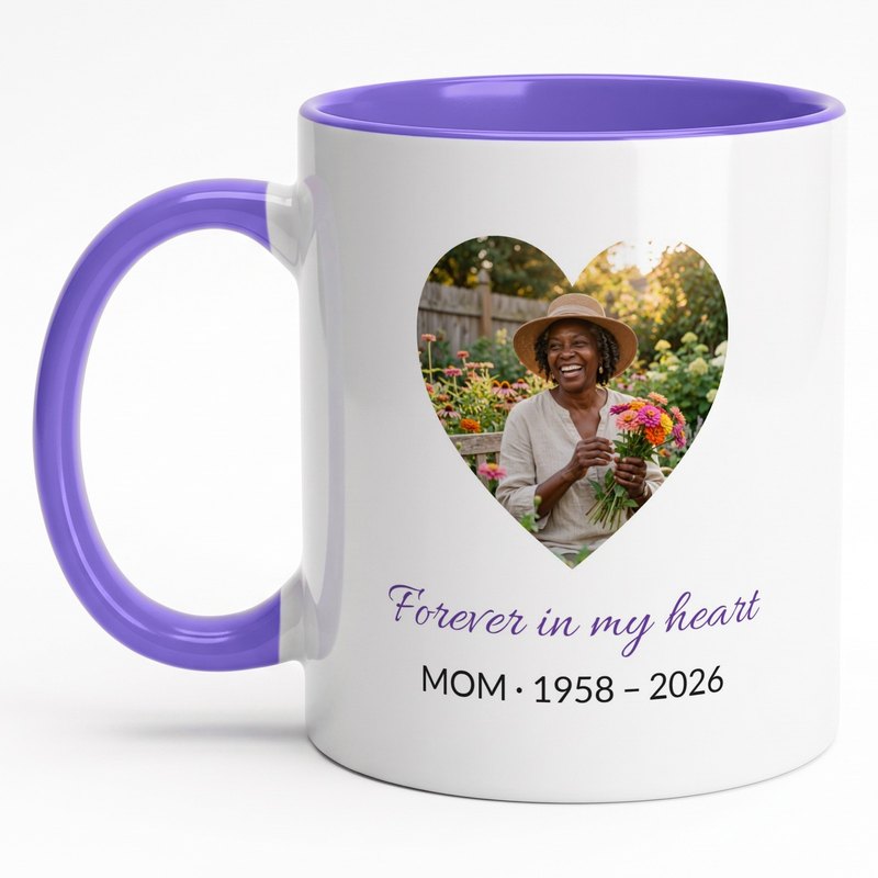 A purple-rim memorial mug with a mother in a garden in a heart, "Forever in my heart" and "Mom · 1958 – 2026"