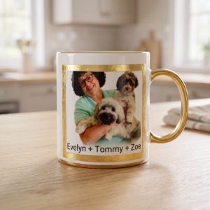 A gold rim mug we made: a woman with two dogs and their names in a gold leaf border
