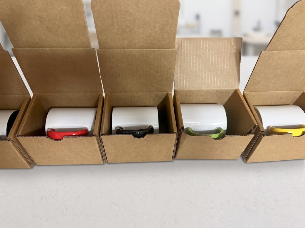 Finished mugs packed in their shipping boxes with protective inserts